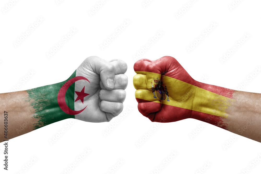 Two hands punch to each others on white background. Country flags painted fists, conflict crisis concept between algeria and spain - obrazy, fototapety, plakaty 