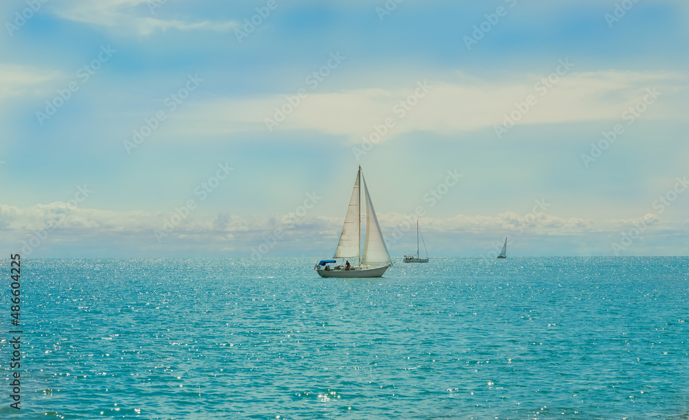 Fototapeta premium Stunning amazing inviting view on lake Ontario from center island,Toronto, with people on yachts, sail boats relaxing and enjoying their summer time 