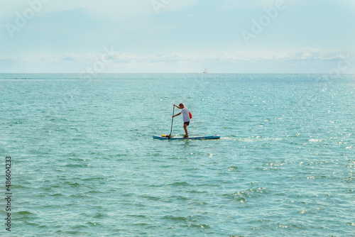 Lake Ontario gorgeous view with man floating on a paddle boat, sunny amazing day © Vit