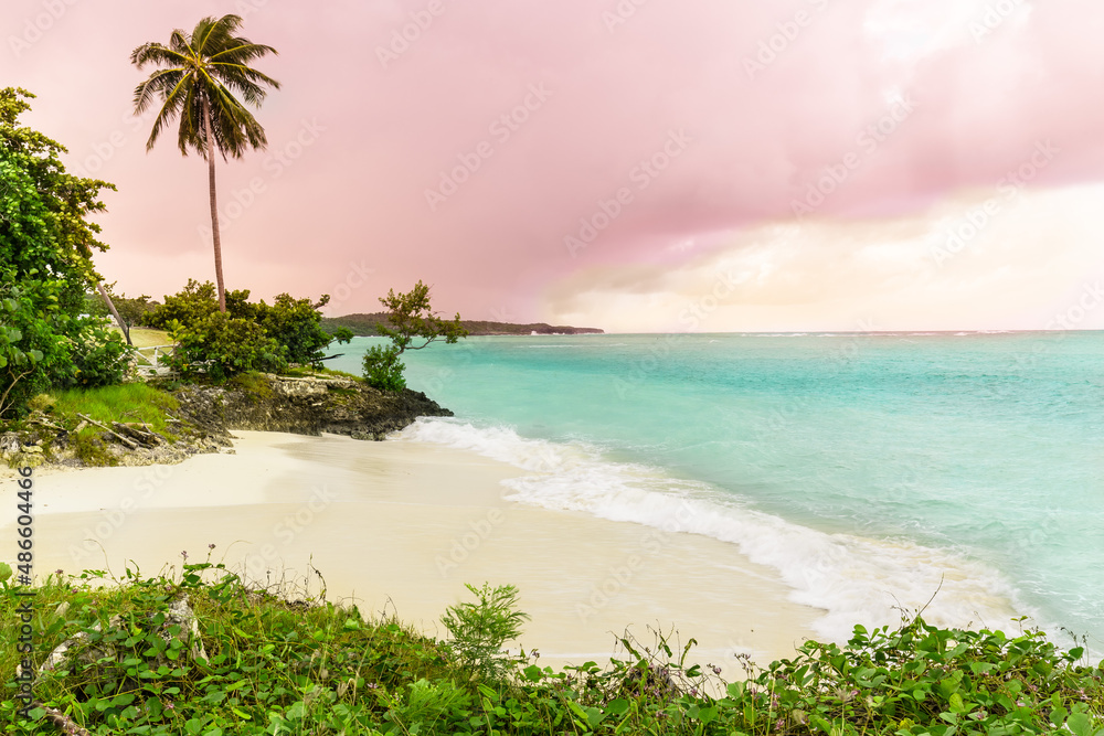 Holguin province, Cuba, gorgeous view on Guardalavaca beach with stormy turquoise ocean and pinkish sunset sky background 