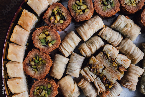 assorted circular tin of middle eastern baklava filo dough pastry sweets	