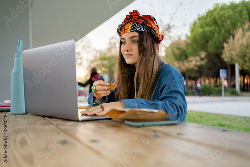 Pretty woman with laptop at university campus  photo