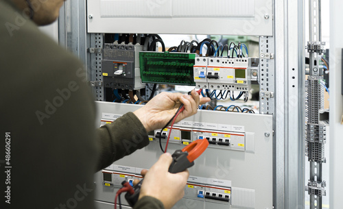 electrician measuring voltage with a digital multimeter