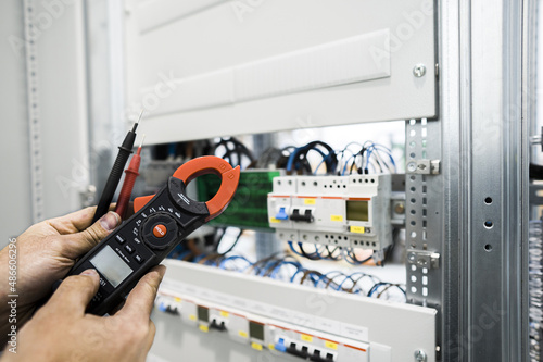 electrician measuring voltage with a digital multimeter