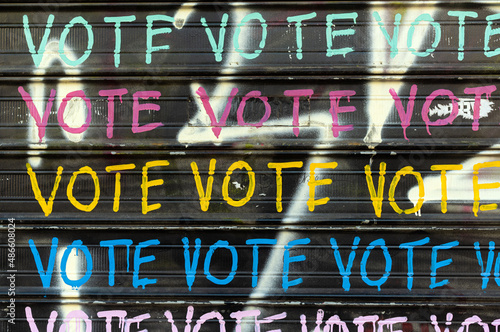 Wall with graffiti that says VOTE