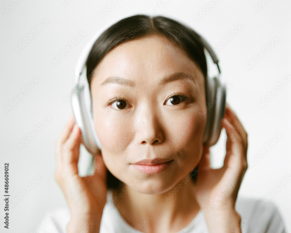 Minimalistic portrait of a woman in silver headphones Minimalistic portrait of a woman in silver headphones
