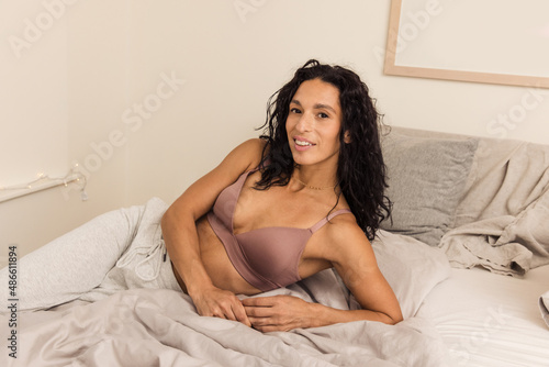 Beautiful woman lounging in bedroom photo