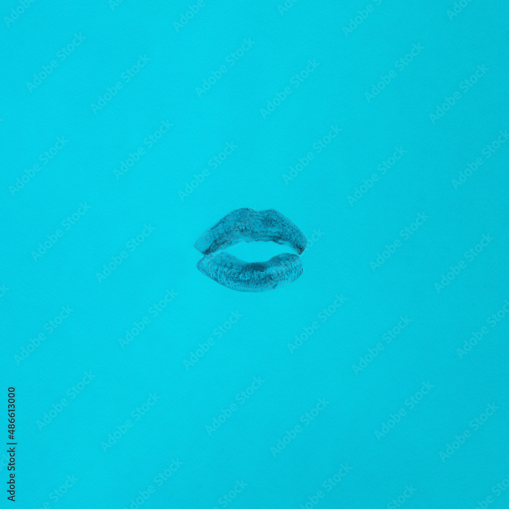 Kiss with lips on a vibrant blue background. Flat lay Valentine concept. Love lipstick design idea. Minimal aesthetic Kiss with lips on a vibrant blue background. Flat lay Valentine concept. Love lipstick design idea. Minimal aesthetic