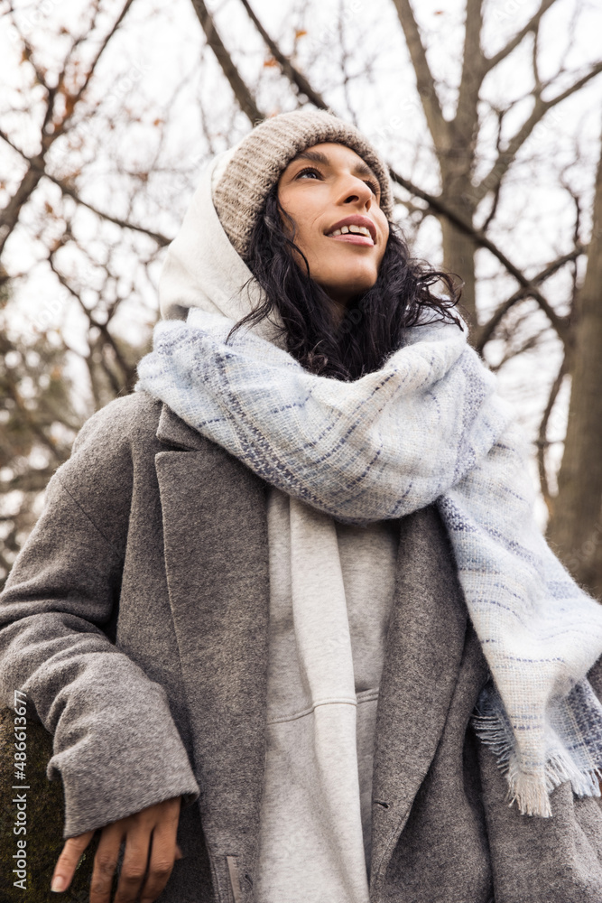 Model wearing wool coat and beanie outdoors Model wearing wool coat and beanie outdoors