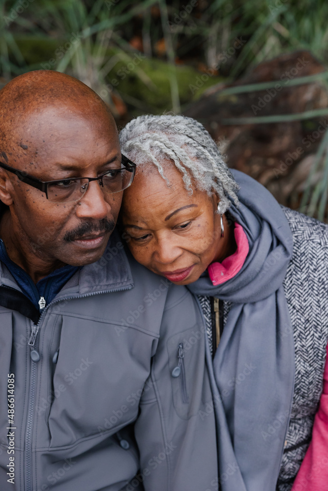 Older couple talking together outside in nature. Older couple talking together outside in nature.