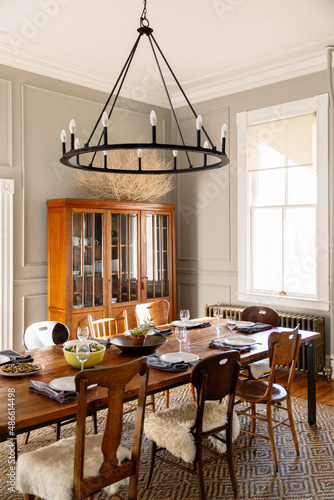 Photography A table set for dinner in a rustic modern farmhouse with sunlight coming through a window