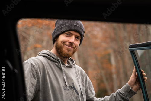 Portrait of smiley  bearded man in the forest