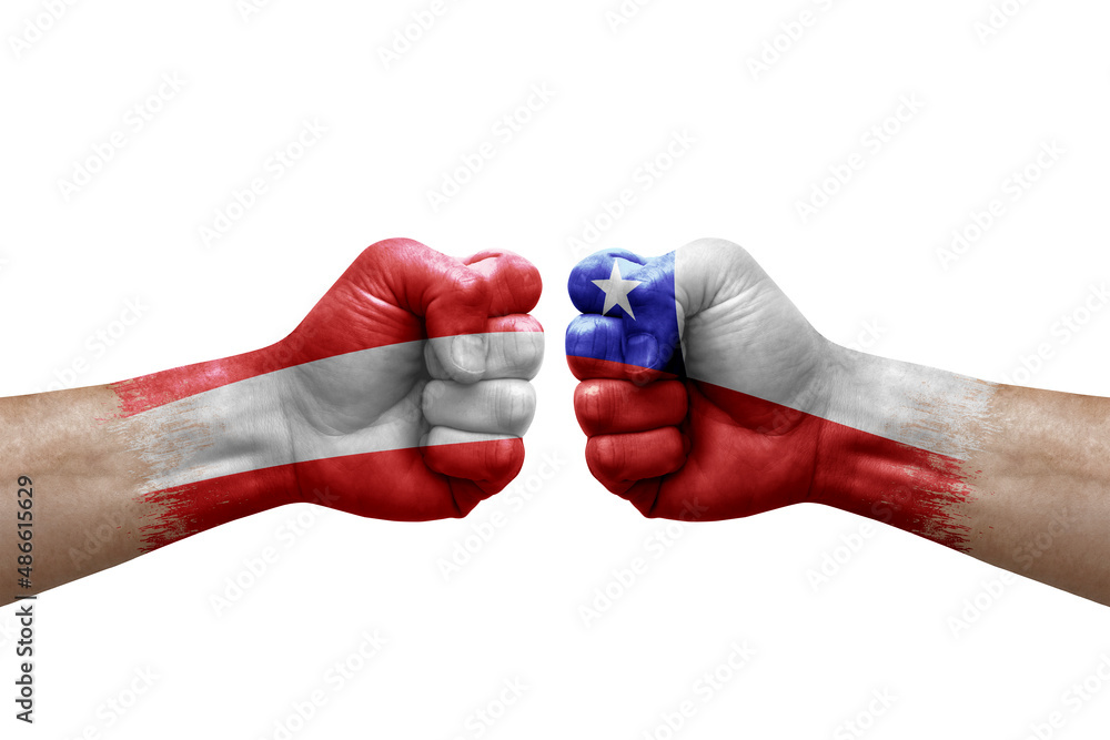 Fototapeta premium Two hands punch to each others on white background. Country flags painted fists, conflict crisis concept between austria and chile