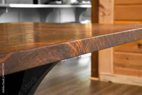 Close up of walnut solid wooden dining table. Claro Walnut wood table.