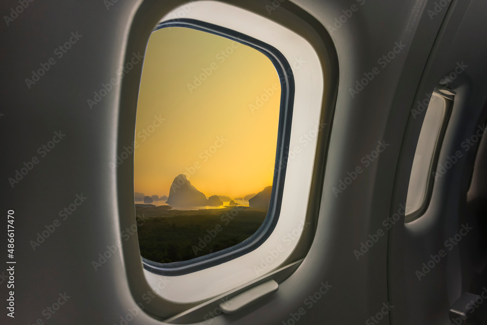 Concept image of touring and transportation, airplane's window with Samed Nang Shee ariel view in Thailand.
