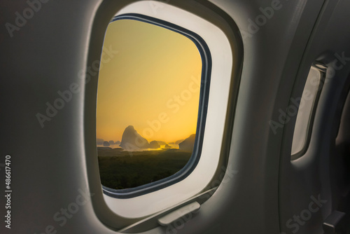 Concept image of touring and transportation, airplane's window with Samed Nang Shee ariel view in Thailand.