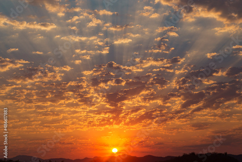 sun in the middle of a sky full of clouds