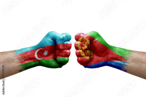 Two hands punch to each others on white background. Country flags painted fists, conflict crisis concept between azerbaijan and eritrea photo