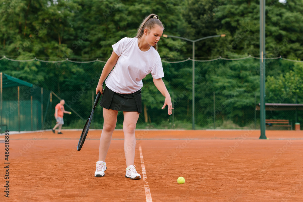Young girl practicing tennis on the tennis court Young girl practicing tennis on the tennis court