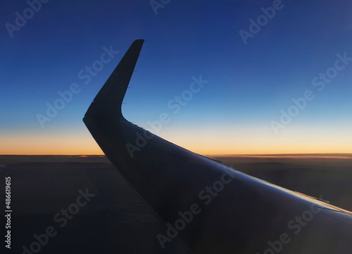 blu sky, sunset horizon line and airplane wing photo