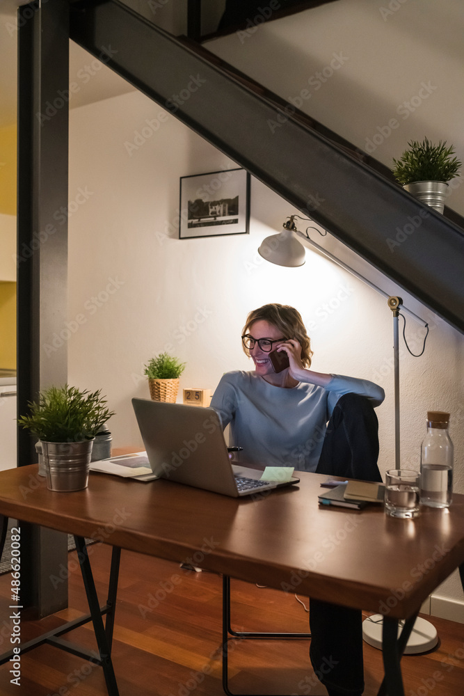 Woman working from home at night Woman working from home at night
