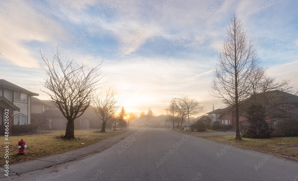 Fraser Heights, Surrey, Greater Vancouver, BC, Canada. Beautiful Street view in the Residential Neighborhood during a colorful Winter Season. Dramatic Sunrise Sky. Fraser Heights, Surrey, Greater Vancouver, BC, Canada. Beautiful Street view in the Residential Neighborhood during a colorful Winter Season. Dramatic Sunrise Sky.