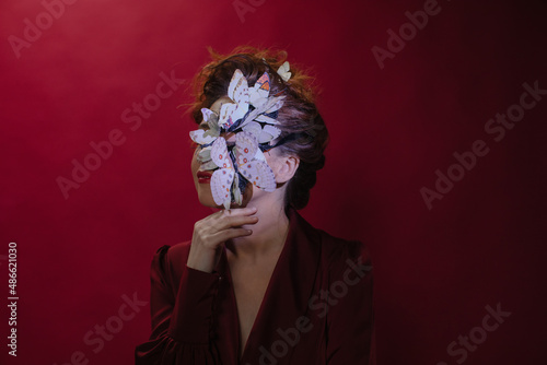 Anonymous woman with butterflies on her face