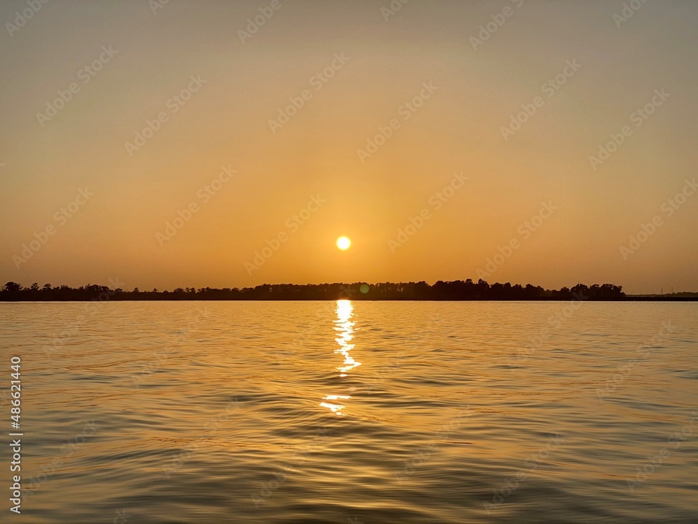 Naklejka premium sunset over the river