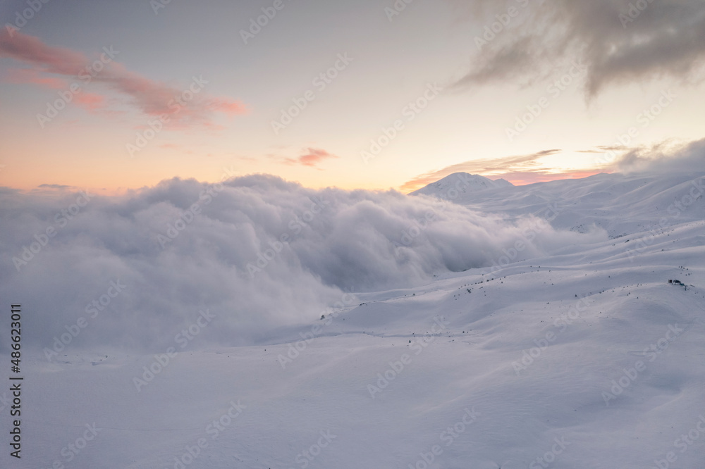 Aerial view of clouds and snowy mountain Aerial view of clouds and snowy mountain