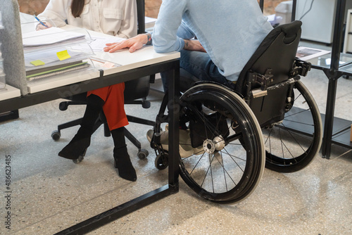 Anonymous Man On Wheelchair Conversation With Colleague photo