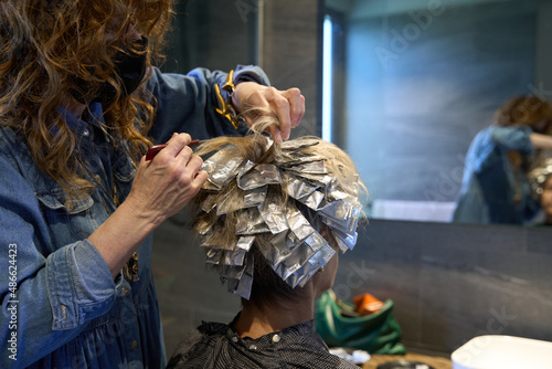 Foils with hair color being applied
