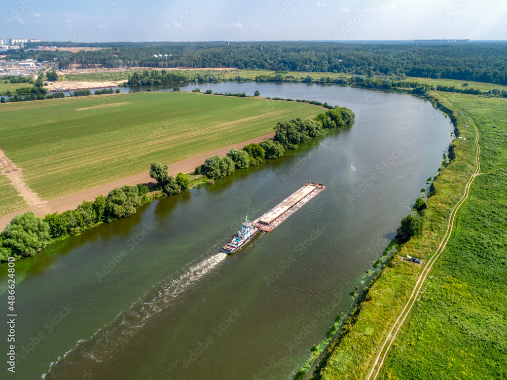 Fototapeta premium A cargo barge floats on the river