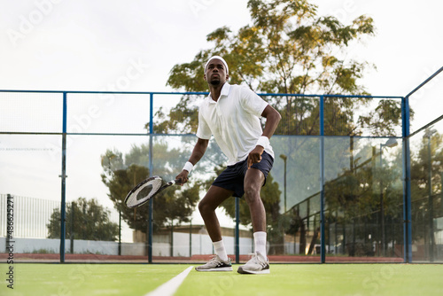 Fit man playing tennis photo