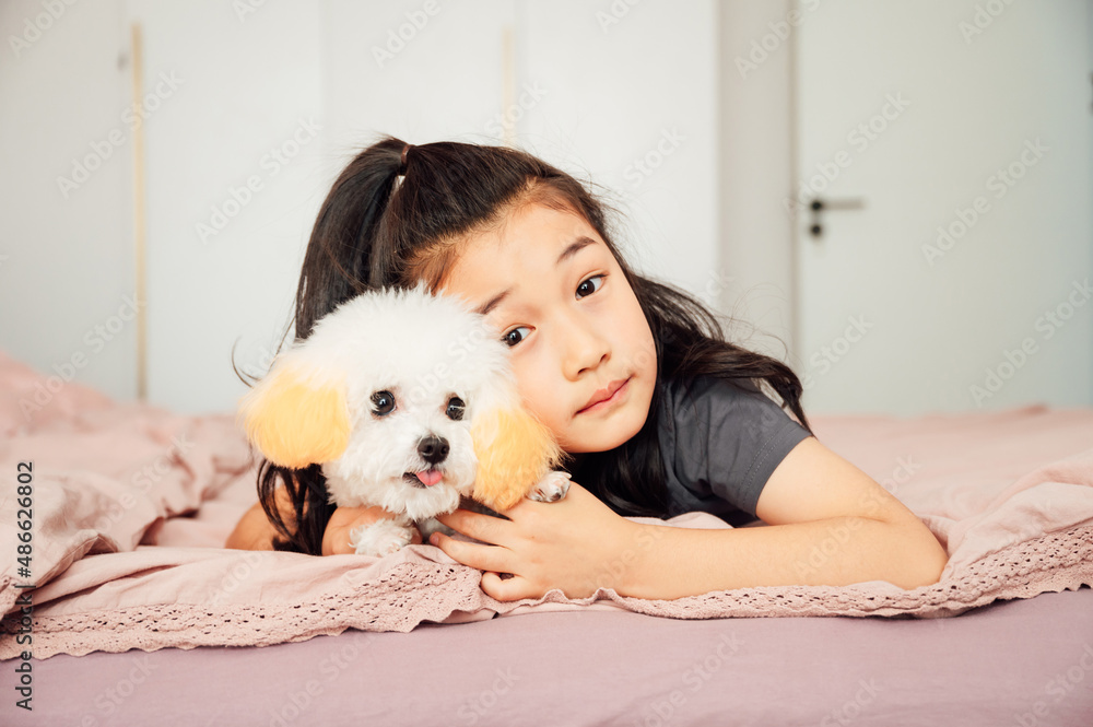 Cute Asian girl playing with puppy Cute Asian girl playing with puppy