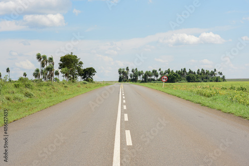 Signposted road and green field