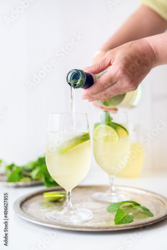 Pouring Prosecco  to gin Hugo cocktail drink photo