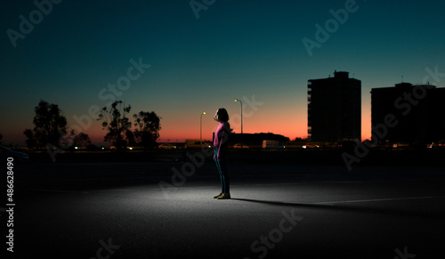 Mysterious standing woman during sunset photo