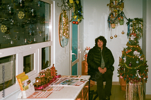 Young man sited in an entrance hall waiting new year