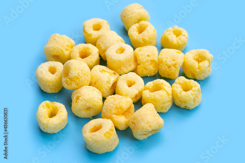 Roller corn snack on blu background.