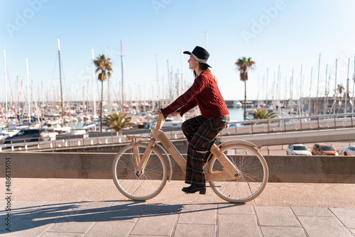 Female cyclist riding lumber bike in city photo