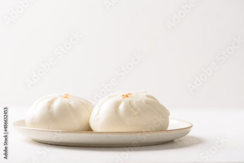 Steamed Chinese bun on white background, a popular Asian street food
