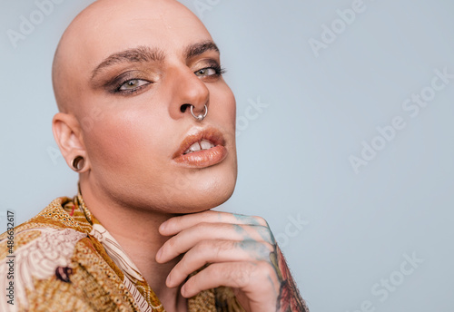 Young trendy man with bright makeup
