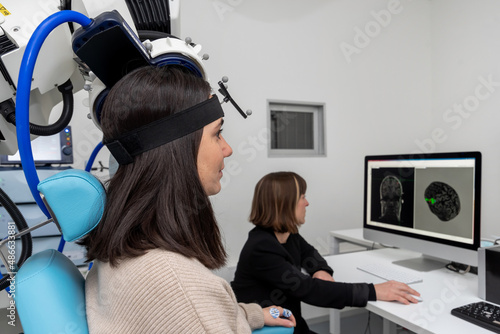 Patient doing TMS in modern laboratory