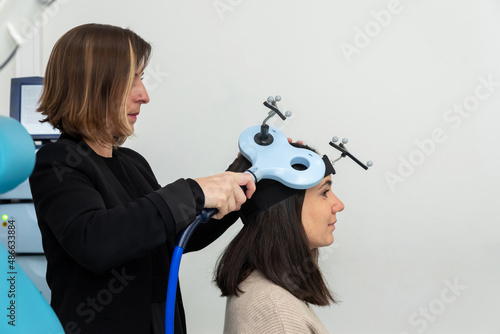 Researcher applying TMS on patient photo