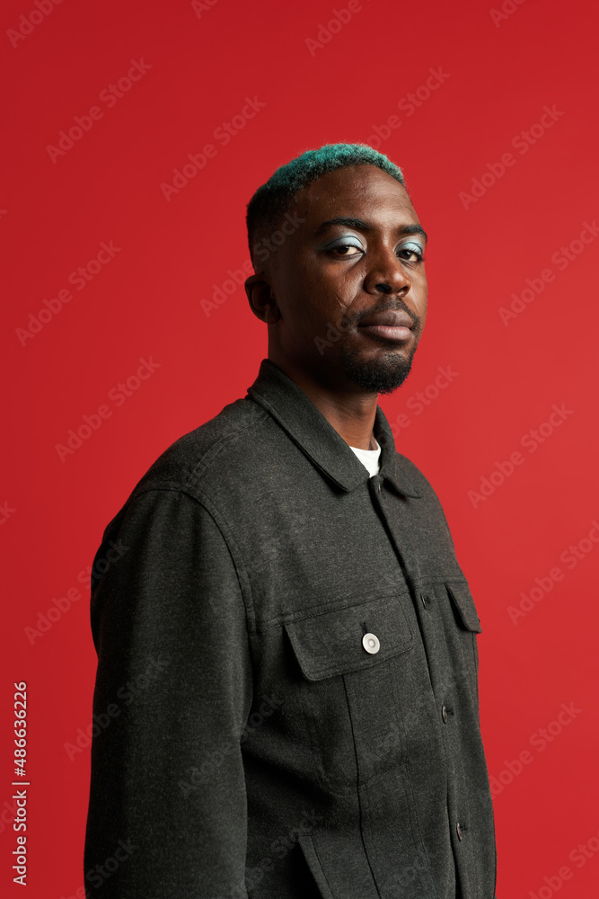 Serious black man with dyed hair and makeup Stock Photo | Adobe Stock