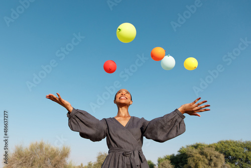 A woman with balloons outdoors