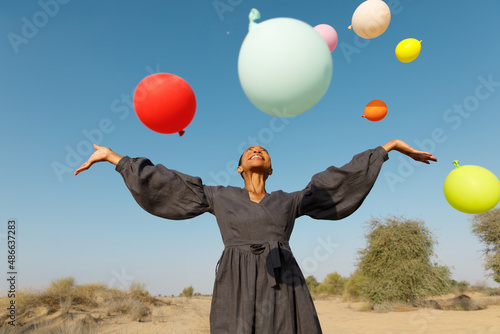 A cheerful woman with balloons photo
