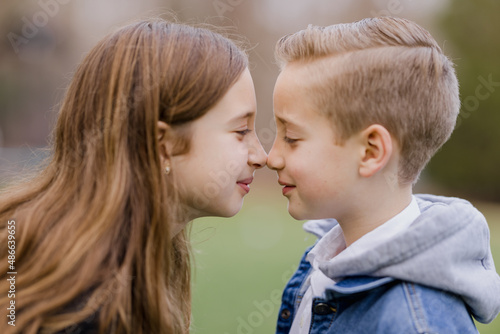 Sister and brother nose to nose photo