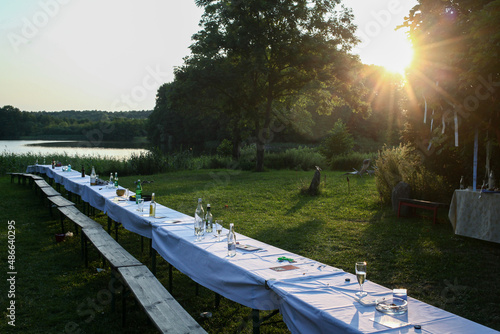 Long table in a garden during sun set photo