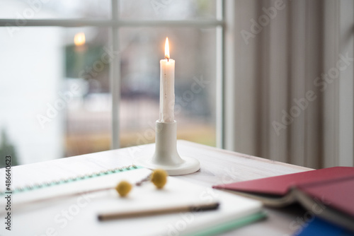 Single candle burning on table